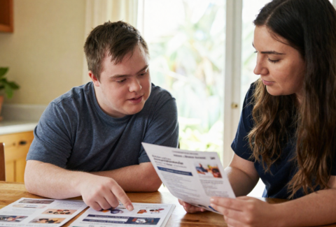 support worker and client looking at paperwork